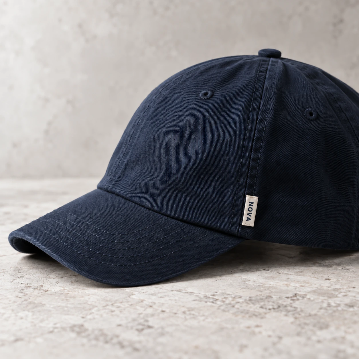 Small woven brand tab in a cap side seam